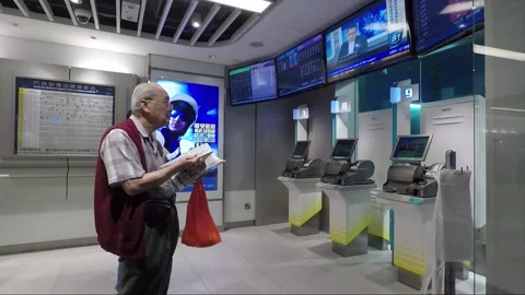 The man checking his bets at the betting shop, Hong Kong 库存影片 143457300
