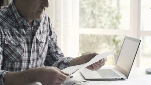 Man checking his bills and managing home finances Stock Footage 103203035