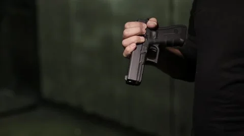 Man checking his gun Stock Footage 61570785
