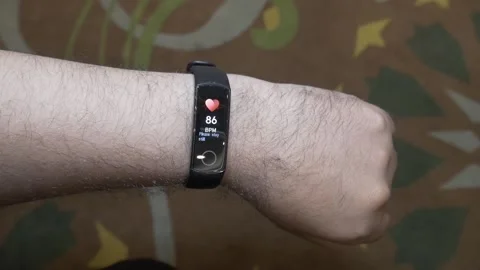 Man checking his heart rate using smart band Stock Footage 239488562