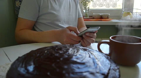 Man checking his mobile phone while having a breakfast Stock-Footage 59703652