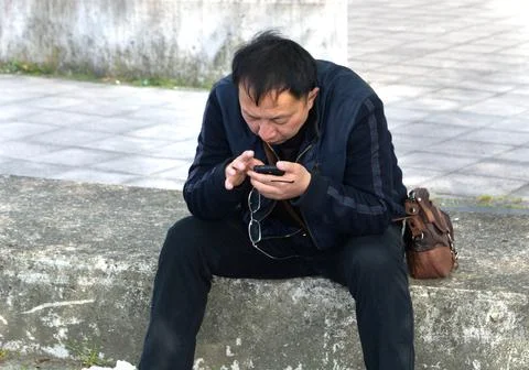 Man Checking His Mobile Phone, Greenwich, South London. Stock Photos