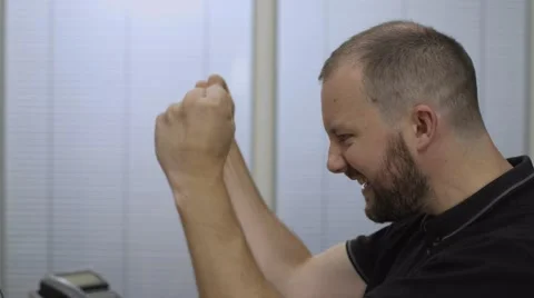 Man checking his online account at work and celebrating success Video stock 68614574