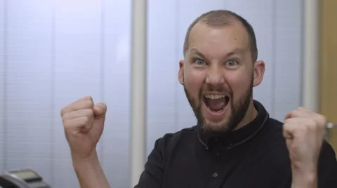 A man checking his online account and celebrating winning to camera Stock Footage 68614580