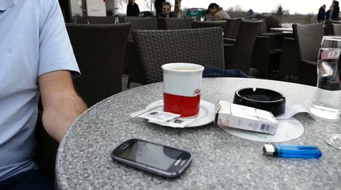 Man Checking His Phone And Then Taking His Coffee Stock Footage 47342251