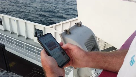 Man checking his phone on a ferry in a summer afternoon Video stock 205041614
