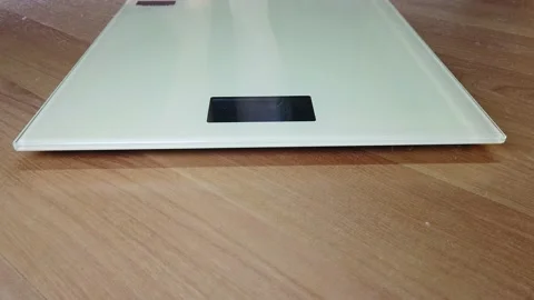 Man checking his weight. Legs on the scales. Stock Footage 147741080