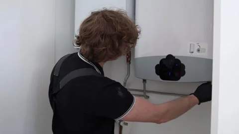 Man checking home water heater Stock Footage 335045570