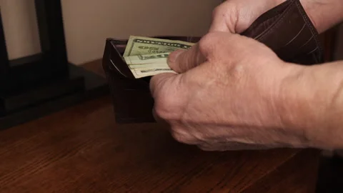 A man checking how much money is in his wallet Stock Footage 234642933