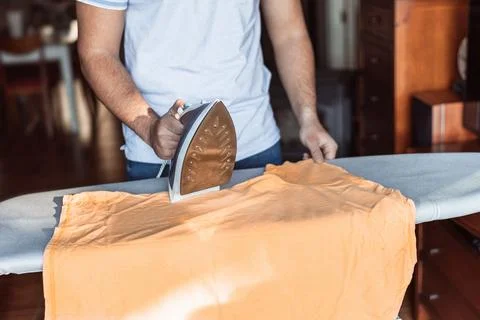 Man checking the ironing machine before starting Stock Photos