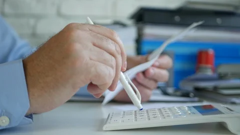 Man Checking a List Calculating with Adding Machine Monthly Payments Stock Footage 108647232