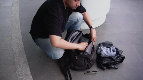 Man checking list travel accessories in backpack. 스톡 동영상 269612193