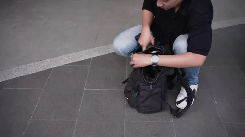 Man checking list travel accessories in backpack. 스톡 동영상 269612243