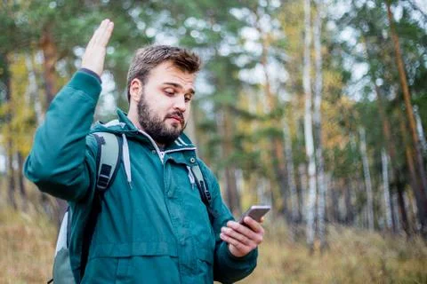 Man checking map on phone while hiking Stock Photos