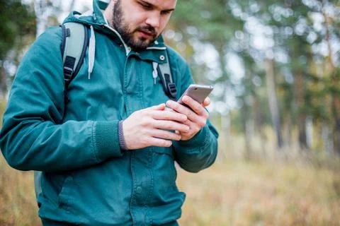 Man checking map on phone while hiking Stock Photos