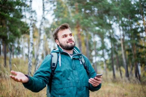 Man checking map on phone while hiking Stock Photos
