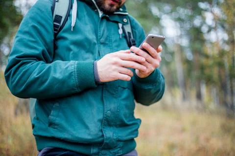 Man checking map on phone while hiking Stock Photos