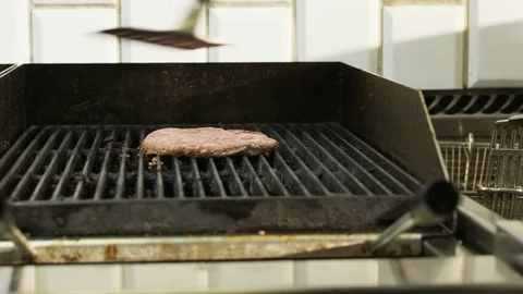 Man Checking Meat on a Grill Stock Footage 71564769