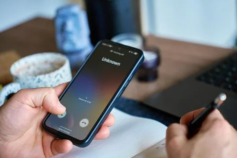 Man checking missed call from unknown number on smartphone Stock Photos