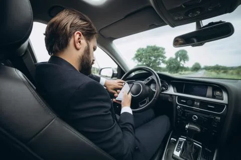 Man checking navigation on smartphone while sitting in car Stock-Fotos