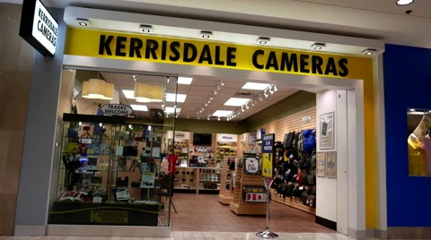 Man checking new camera at Kerrisdale cameras store Stock Footage 56693892