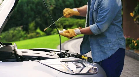 Man checking oil in his car  Видео 41385459