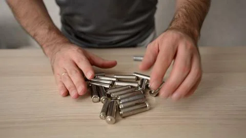 Man checking old dead batteries for recycling Stock Photos