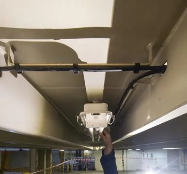 The man checking or changing Fluorescent light tube in the building. Stock Photos