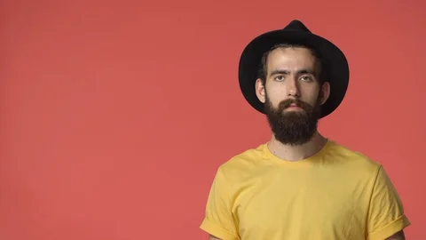 Man checking out really cool thing. Handsome bearded middle-eastern guy in black Stock Footage 115780765