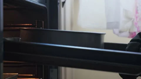 Man checking the oven on the kitchen Stock Footage 163991594