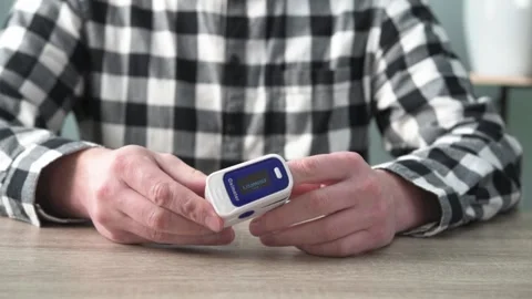 A man checking oxygen level at home with home oximeter, patient measuring the Stock Footage 167559794