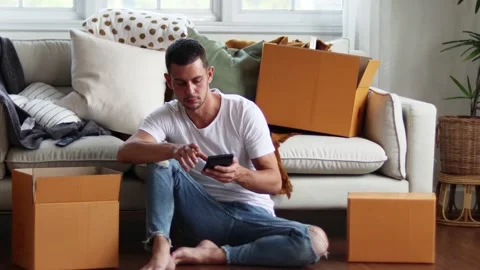 Man checking parcel box with phone and calculator.Concept online seiling. Stock Footage 163088578