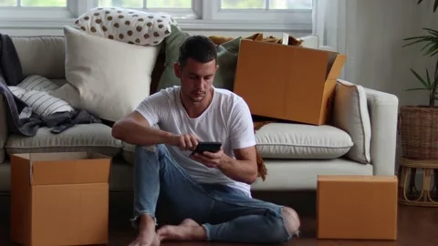 Man checking parcel box with phone and calculator.Concept online seiling. Stock Footage 163088592