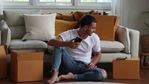 Man checking parcel box with phone and calculator.Concept online seiling. Stock Footage 163088749