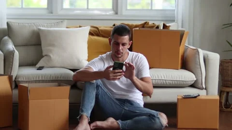 Man checking parcel box with phone and calculator.Concept online seiling. Stock Footage 163088868