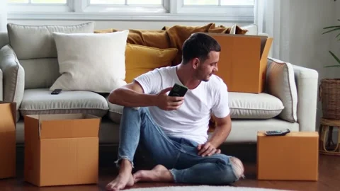 Man checking parcel box with phone and calculator.Concept online seiling. Stock Footage 163088949