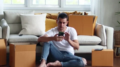 Man checking parcel box with phone and calculator.Concept online seiling. Stock Footage 163088951