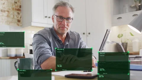 Man checking phone and sorting papers at table, green HUDs expanding over Stock Footage 334744528