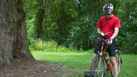 Man Checking Phone on Bike Handlebars Stock Footage 77922631