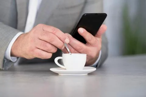 Man checking the phone on a coffee break Stock Photos