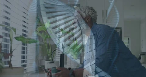 Man checking phone for tech alert leaning on counter, helix overlay hovering Stock Footage 333910833
