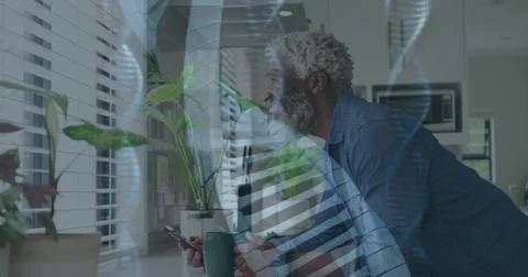 Man checking phone for tech alert leaning on counter, helix overlay hovering Stock Photos