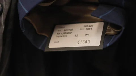 A Man checking the price of an expensive suit Stock Footage 254483503