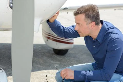 A man checking at the propeller Stock Photos