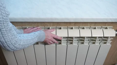 Man is checking radiator is it heating Stock Footage 318072403