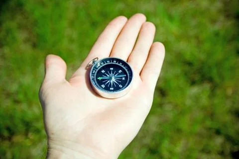 Man checking retro compass for right direction Stock Photos