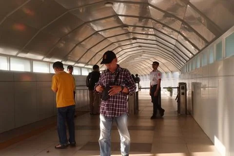 Man Checking Sling Bag in Station Corridor Stock Photos