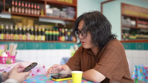 Man checking smartphone during restaurant meal Stock Footage 346302997