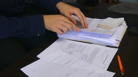 Man Checking a Stack of Documents Stock Footage 98395998