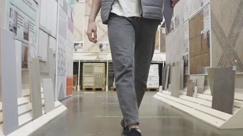 Man is checking supplies on document with an engrossed expression in warehouse Stock Footage 143094534